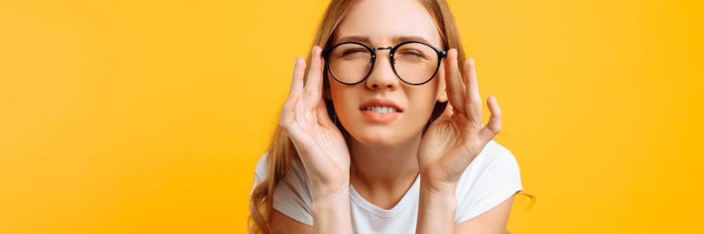 woman squinting through glasses
