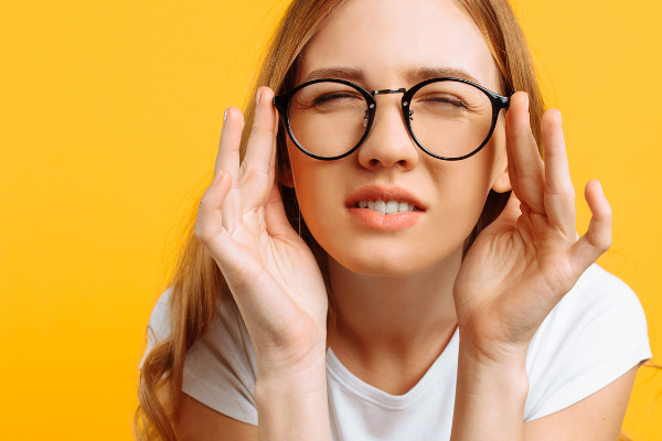 woman squinting through glasses